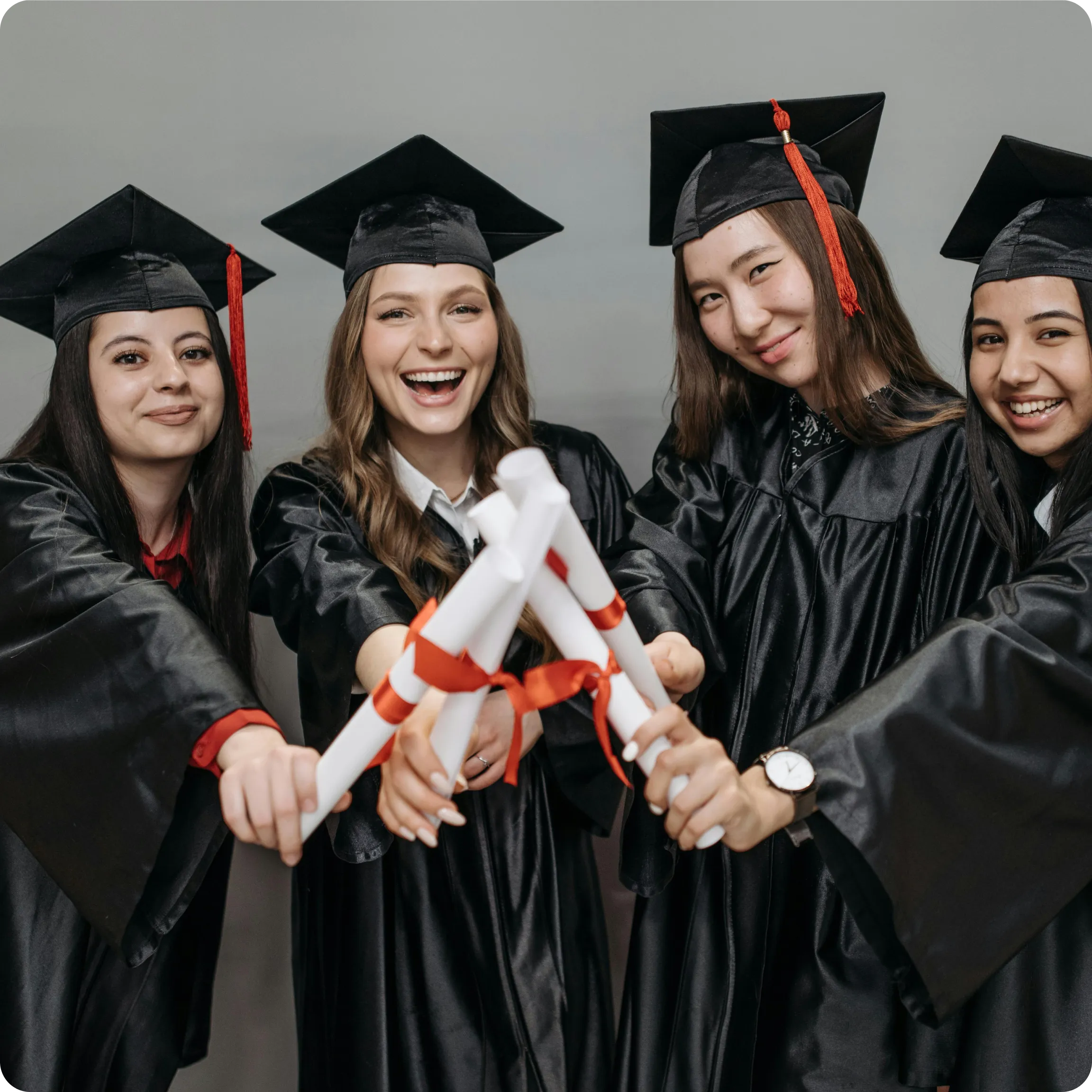 Graduates holding diplomas